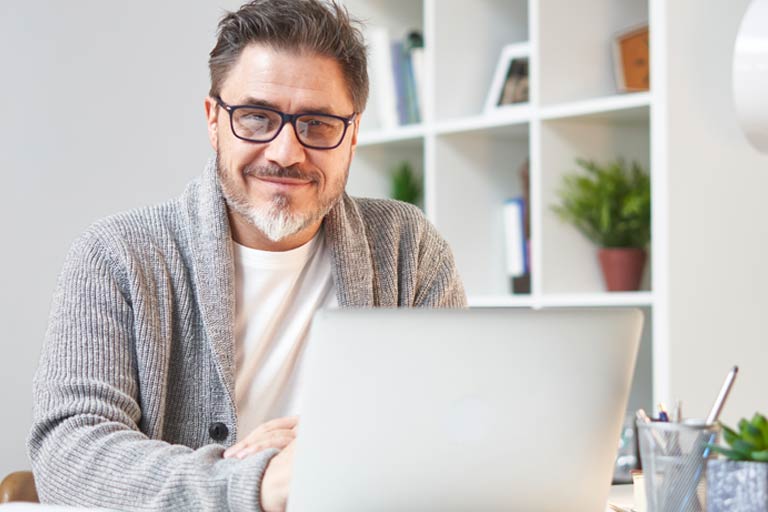 man sitting at computer